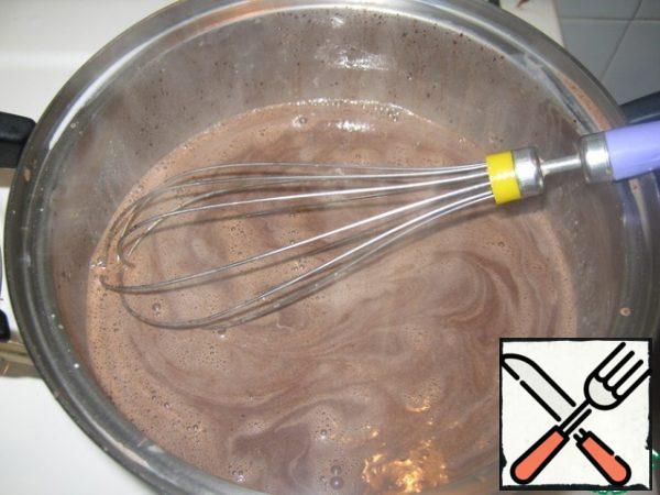 Add chocolate to hot milk and stir. If the chocolate tiles, then pre-break it into pieces.