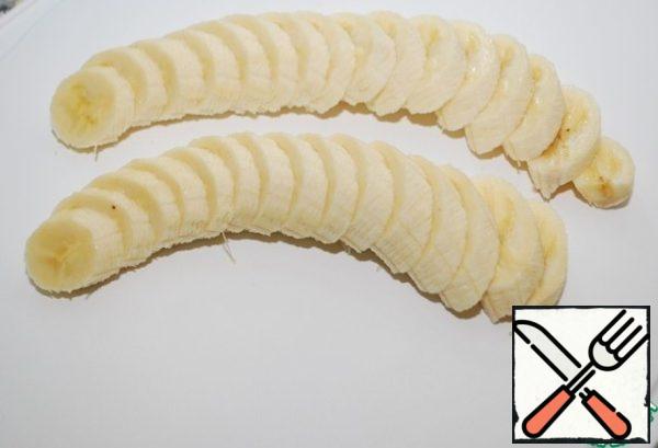 Prepare bananas - one large or 2 small-clean and cut into thin circles.