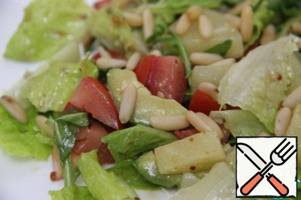 Sprinkle pine nuts on top.