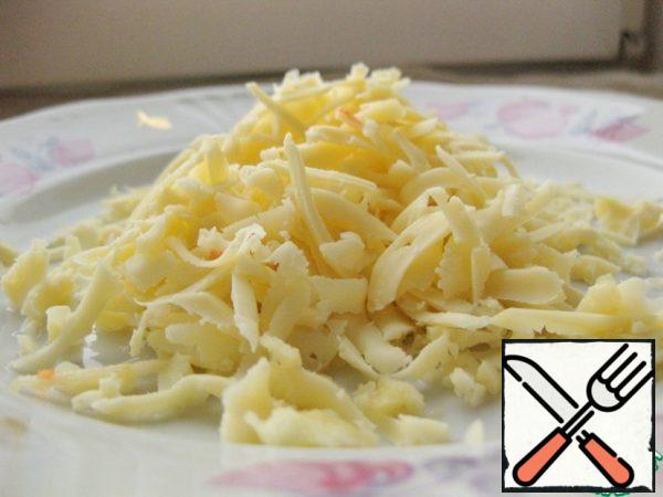 Grate the cheese into thick strips.