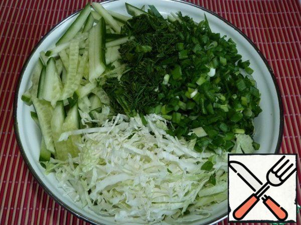 Chop the cabbage. Cut the cucumber (I love cucumber cubes in this salad), dill, green onions.
