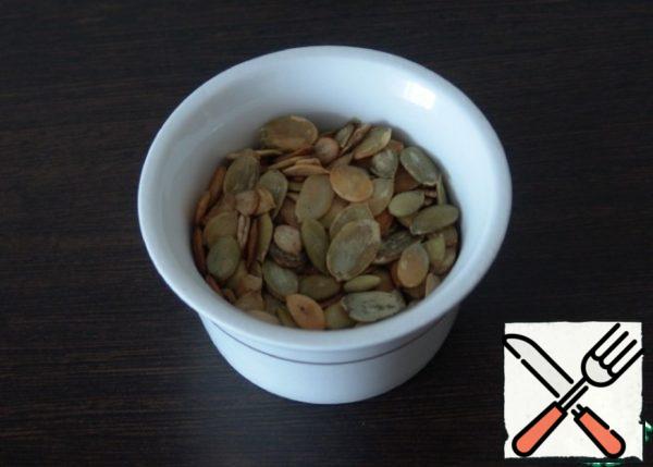 Fry the pumpkin seeds in a dry frying pan.
