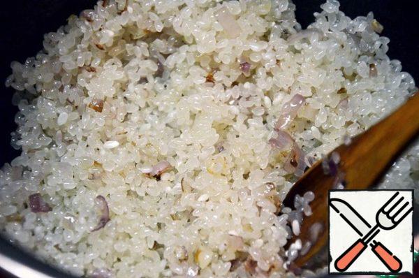 Add the rice and stir. Fry the rice, stirring, for a couple of minutes.

