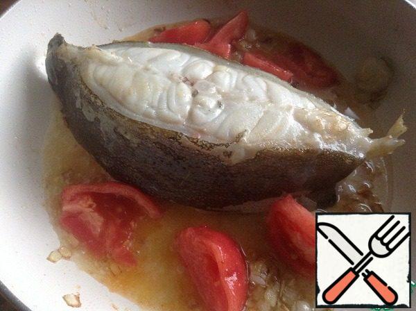 Turn the lancet fish to the other side and add the chopped tomato and dry white wine. Simmer on low heat for about 3 minutes - so that the alcohol evaporates and tomatoes turn into tomato paste.
