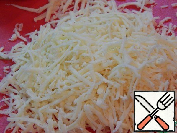 Grate the cheese on a coarse grater.
