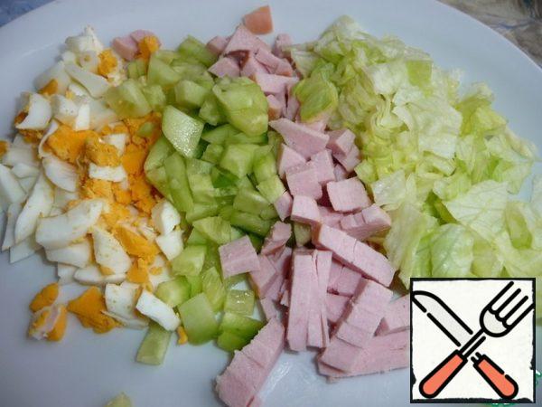 All products for the salad cut into cubes.