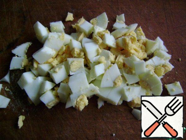 Boil the egg and cut into cubes.
