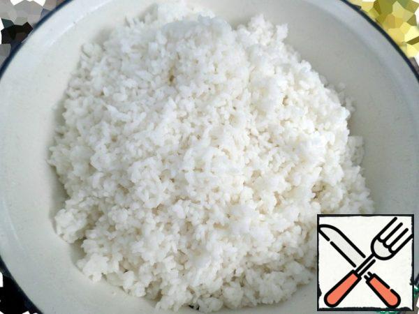 Discard the boiled rice in a colander and rinse with running cold water.
You need to let the water drain and put the rice in a large deep bowl.