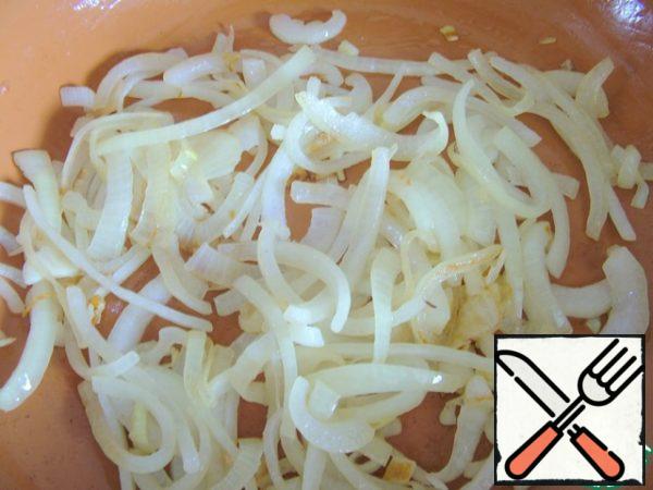 Onions should be cut into half rings and fried until soft.
