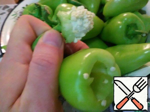 Then I pull the whole stalk out of the pepper by the tail. Just pick out the remaining seeds from the pepper with your fingers.
