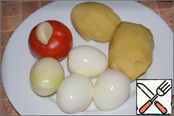 Peel and boil potatoes in lightly salted water - 2 pcs . Also for our salad you will need 3 boiled eggs, a tomato, an onion and a clove of garlic.
