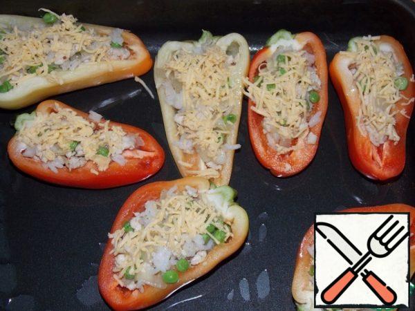 Stuff the peppers with the filling. Sprinkle grated cheese on top. Bake at 180C for 20-25 minutes.
