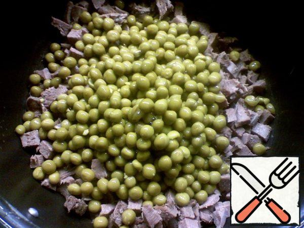 Drain the liquid from the jar of peas.

