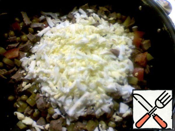 Boil the eggs and grate them.
