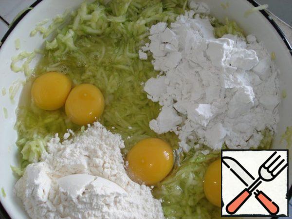 Grate the peeled zucchini. Add eggs, flour, starch and salt. Mix everything together and let it stand for the starch to disperse.
