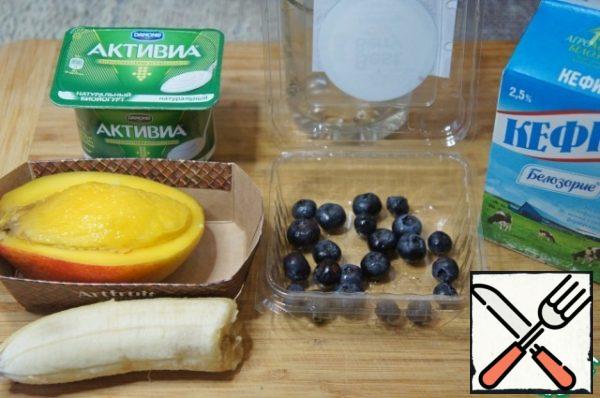 Wash and peel the mango, banana and blueberries.
