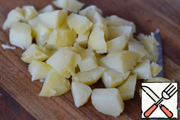 Boil potatoes in their skins.
Peel and cut at random.