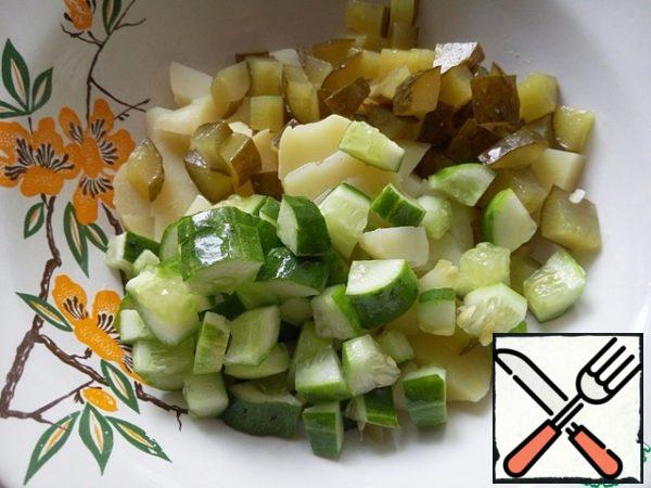 Similarly, cut cucumbers, add to potatoes.
