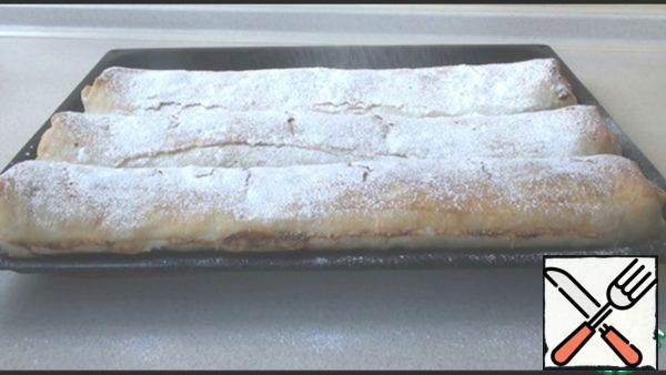 Take a fork and prick the rolls on top so that there is a place for hot air to escape. Brush them with the remaining oil and send them to a preheated 180 degree oven for 40 minutes. The finished strudel is allowed to cool under a towel, then sprinkled with powdered sugar. In my opinion, it always tastes better when it's in the refrigerator, but you can eat it hot! Enjoy your meal!