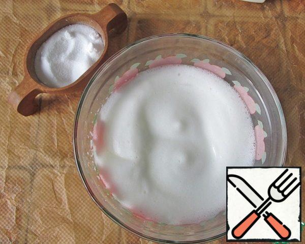 Whisk the egg whites with a pinch of salt.
