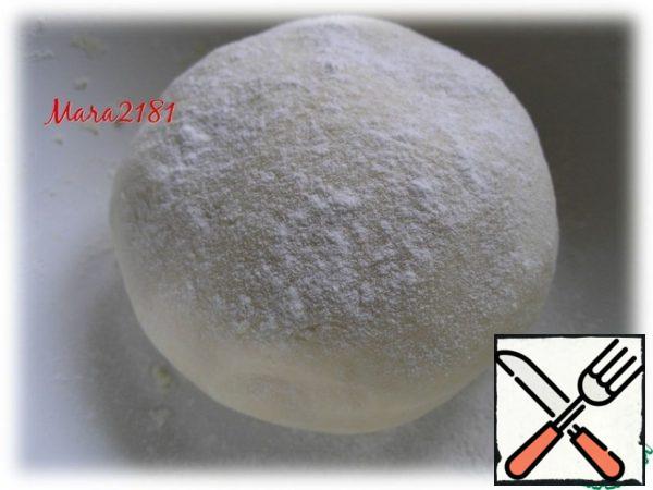 Here is such a snow-white elastic dough I got. Sprinkle it with flour and let it stand for about 30 minutes in a warm place, previously covered with a towel.
