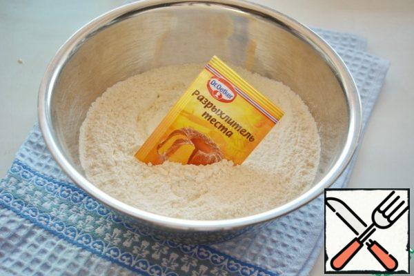 In a separate bowl, mix the sifted flour and baking powder for the dough.
