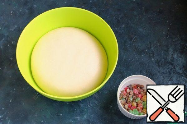 Roll the raisins and candied fruits in flour (1.5 tsp.), shake off the excess.
Pre-rinse the raisins in cold water and soak in boiling water for 15-20 minutes or in brandy. Then dry it on a paper towel.
Knead the dough and add the raisins and candied fruits.