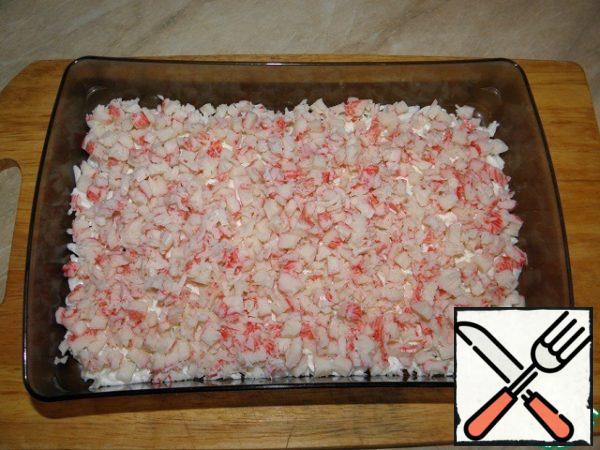 Next comes a layer of finely chopped crab sticks (also to miss).
