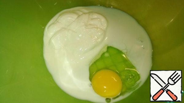 In a deep bowl, mix the sour cream, milk and egg well.
