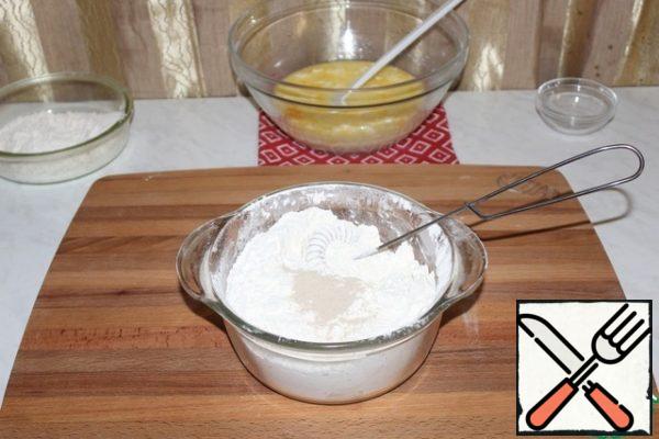 Add yeast to the sifted flour.
