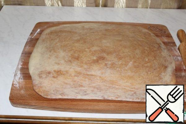 Roll out into a rectangle the size of a baking sheet.
