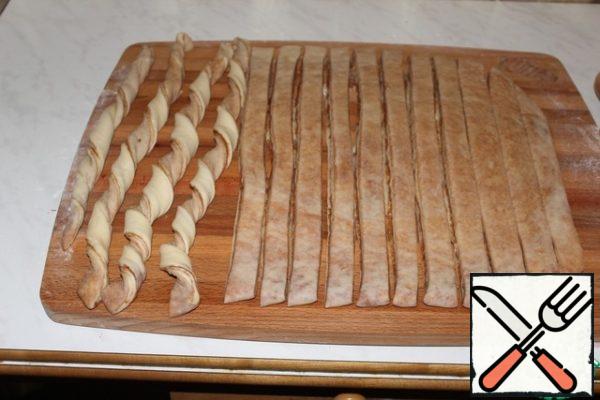 Twist the strips into spirals.
