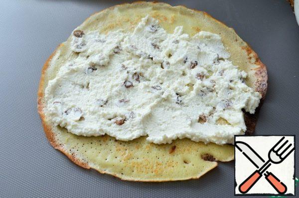Put 2 tablespoons of cottage cheese on a pancake and distribute.
Roll it out. Fill 4 pancakes. Cut each into 5 pieces.
