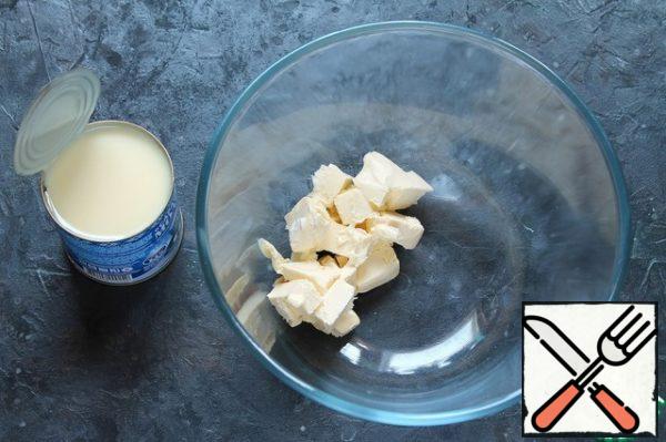 Whisk butter at room temperature with condensed milk.
