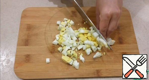 Boil the eggs. I cook them for 10 minutes after the water boils. Cut boiled eggs into cubes.