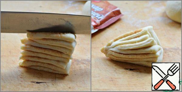 With the back of the knife, press down on the stack of test triangles with a little effort. (press against the base of the triangle, but try not to cut them)
