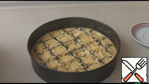 Take a sharp knife and make incisions on the dough in the form of cells. Then put a square of cheese in each cell. Mix the yolk with 2 tablespoons of milk and lubricate all this beauty. To decorate the slices, sprinkle with sesame seeds or flax seeds. We send our beautiful bread to a preheated 180-200 degree oven for 20-25 minutes. Enjoy your meal!