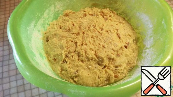 Pour in the remaining flour in parts and knead the dough. Cover the bowl and put it in a warm place for an hour so that it doubles in size.
