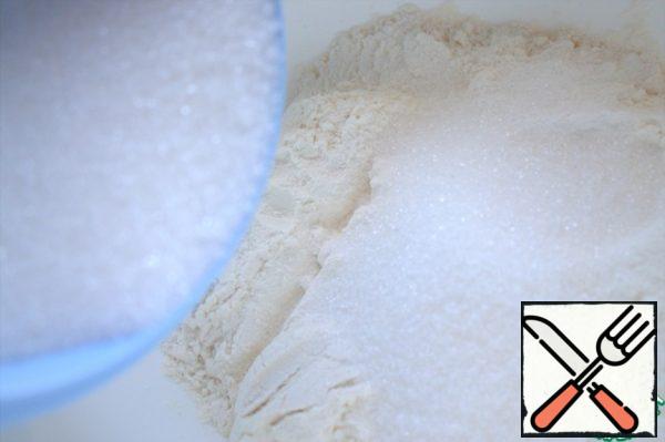 Add baking powder to the flour. Add fine sugar - about half of 200 g.
