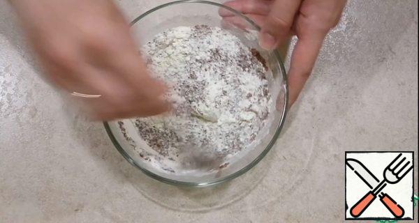 The chocolate bar is divided into two parts. Grate one part on a fine grater. Add to the dry ingredients.

