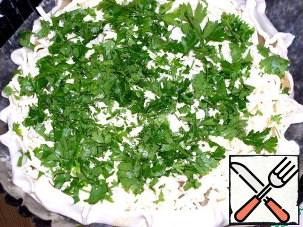 Then put the pre-grated cheese, onion and fried onion to the egg in layers on one half. Then put the chopped greens and add a little salt.
