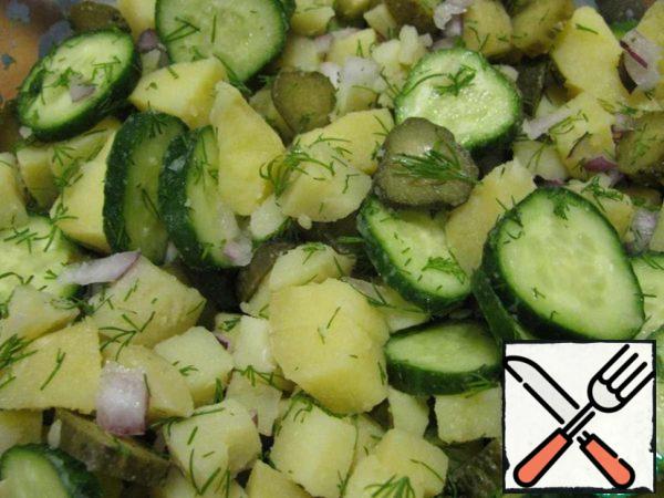 Mix fresh cucumber, onion, pickles, potatoes and half of the dill greens.
