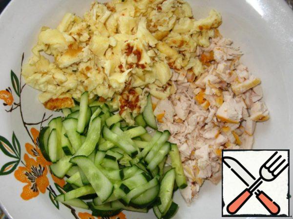 Eggs boil, cool, peel and cut.
Instead of boiled eggs to prepare egg crepes and cut them in strips.
Chicken and cucumbers cut into cubes.