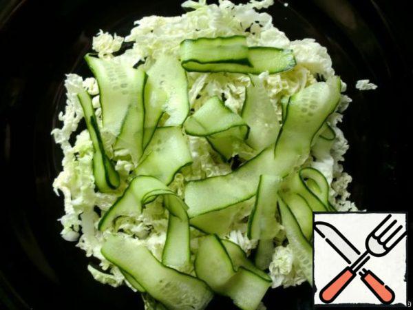 Cucumbers cut into thin strips using a vegetable cutter.
