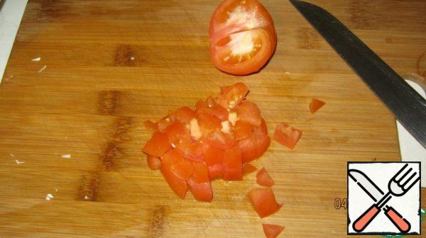 Cut tomatoes into cubes.
