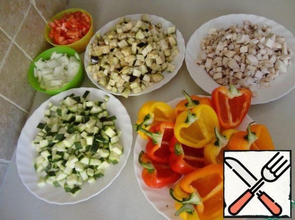 Cut the pepper in half right along with the stalk, remove the seeds and partitions;
cut the remaining vegetables (onions, mushrooms, zucchini, eggplant and tomatoes) into cubes.