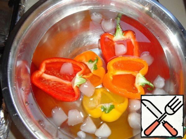 Scald two halves of pepper and immediately dip into ice water.