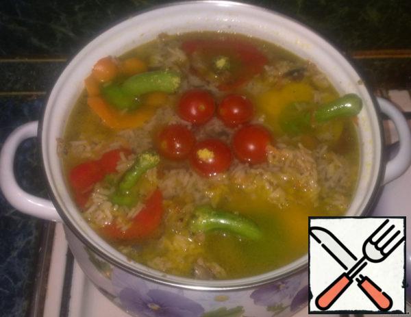 As soon as the pepper in the pot swells, we distribute the remaining filling around the perimeter of the pan, slowly pour broth or warm boiled water into the center of the pan (so that it only covers our peppers), it is best if the broth is salty, before pouring in water, add salt. Put some cherry tomatoes on top of the peppers. Cook our peppers for 20-25 minutes on low heat. After the time has elapsed, cover with a lid, let it brew for half an hour, serve! I want to add that basmati rice, unlike the usual one, not only gives an unusual taste, but also preserves the integrity of the beans, and on the second day of stuffing your peppers will look like a mess! Enjoy your meal!
