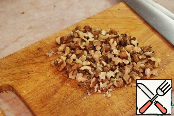Chop the walnuts, mash the salad with your hands and add to the salad.
