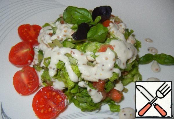 The salad is ready. Garnish with basil leaves and cherry tomatoes.